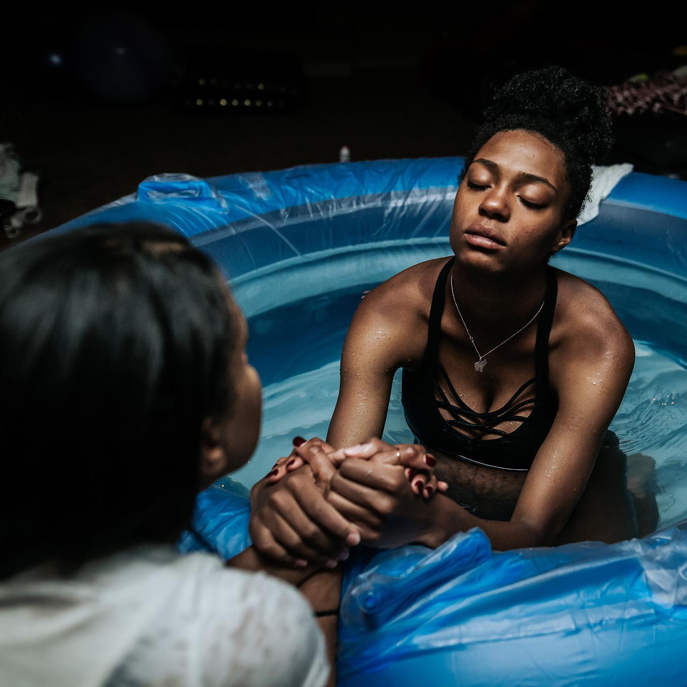 Black pregnant person labors in tub